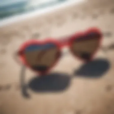 A pair of vibrant bachelorette heart sunglasses on a beach setting.