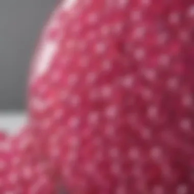 Close-up of vibrant pink glass beads showcased within a decorative vase