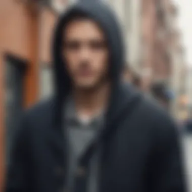 Man wearing a hooded cardigan in an urban setting